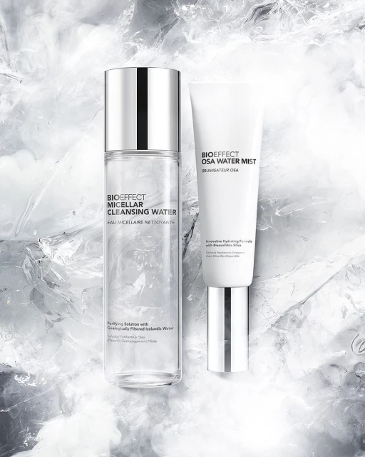 Bioeffect skincare product bottles: Micellar Cleansing Water and OSA Water Mist, in a minimalistic studio setting with ice-like background texture.