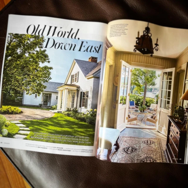 Magazine spread features a house exterior and interior, showcasing architectural and design elements with natural light and landscaping.