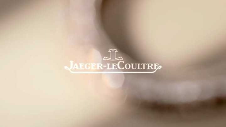 Jaeger-LeCoultre logo in white on a blurred background. Close-up of the luxury watch brand's emblem and text.