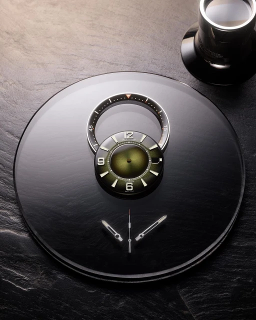 Still life of a deconstructed wristwatch on a black surface next to a teacup, featuring separated watch components and minimalist design.