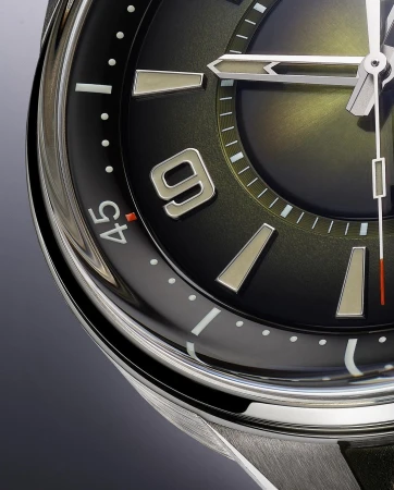 Close-up of a black-faced wristwatch with silver hands and markers. The time shows approximately 10:09. Silver casing and black strap are also visible.