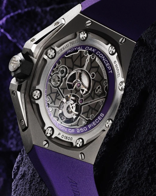 Close-up of an Audemars Piguet Royal Oak Concept watch with a purple band, revealing intricate inner mechanisms against a dark textured backdrop.