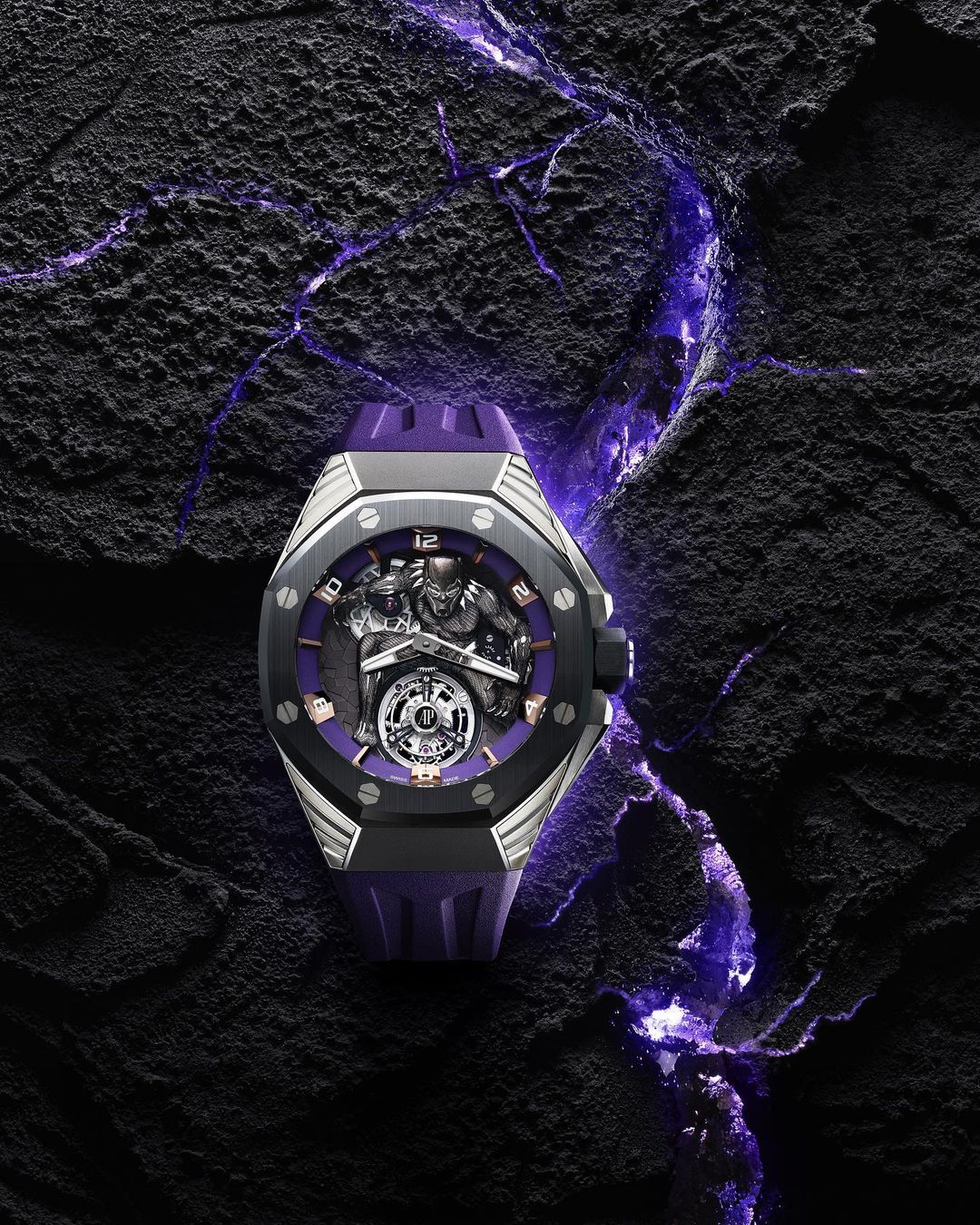 Luxury wristwatch featuring Black Panther design and purple accents, displayed on a textured black surface with purple highlights.