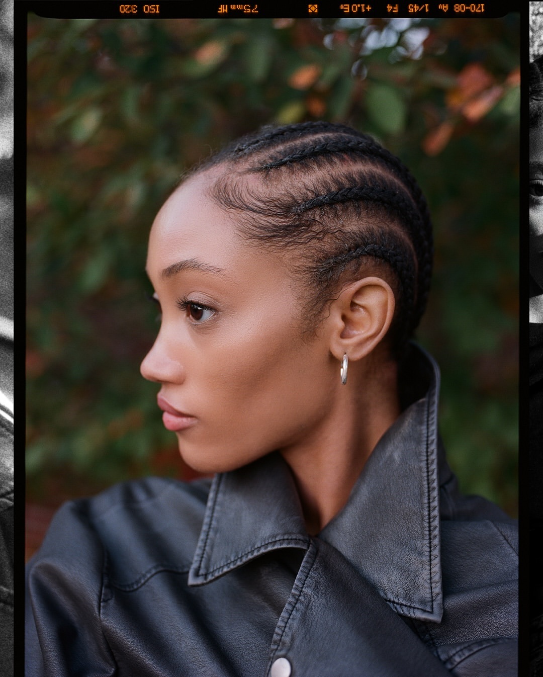 Close-up profile of a woman with braided hair wearing a black leather jacket against a blurred green background with a vintage film border.