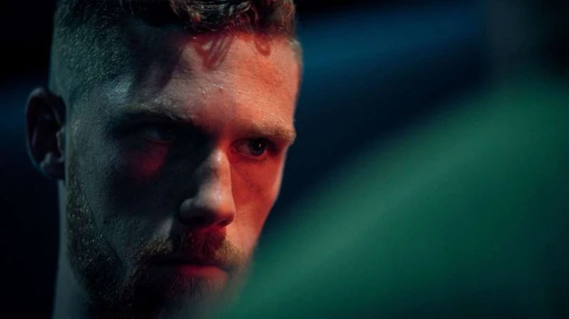 Close up portrait of a white man with reddish beard in dramatic moody lighting by Eric Yip