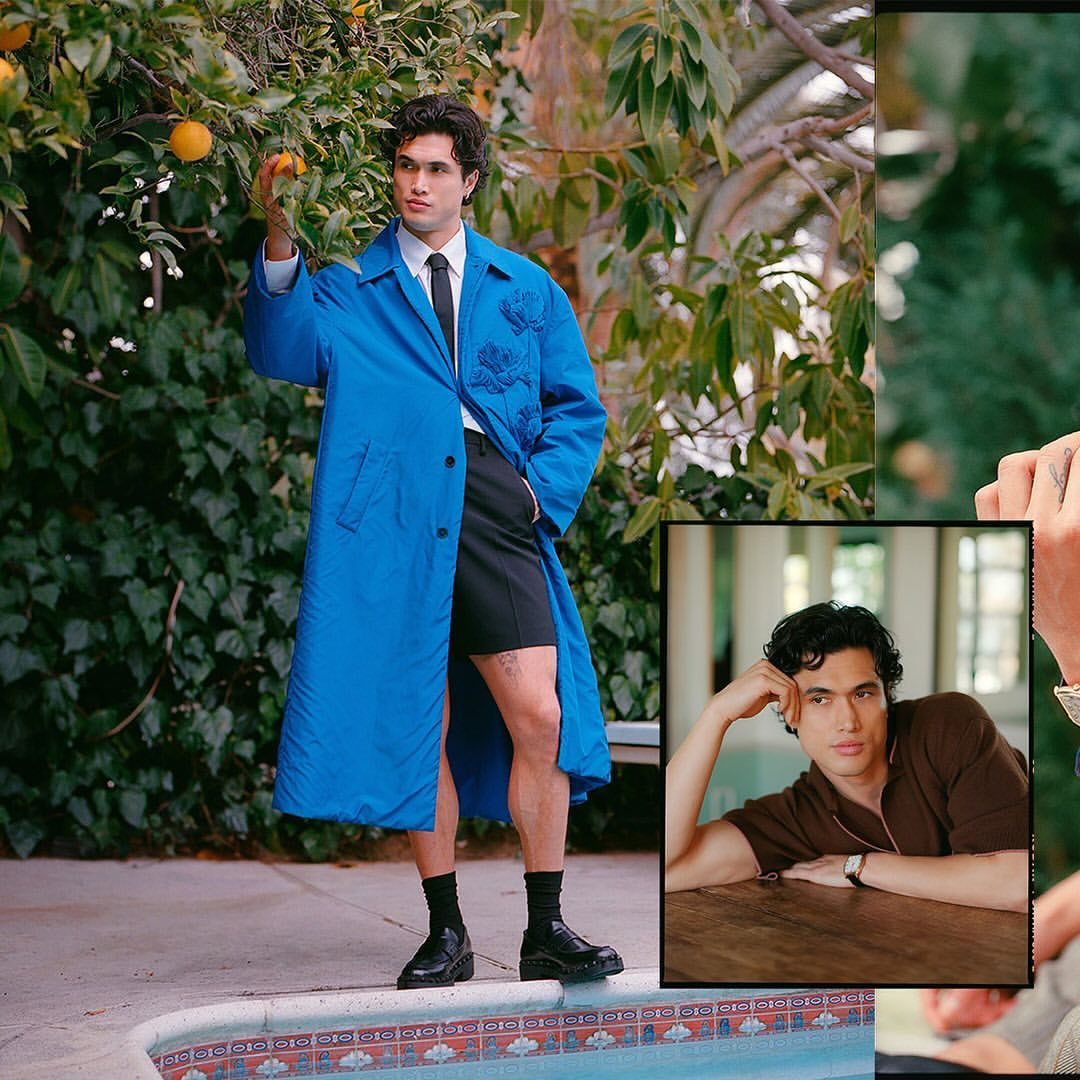A man poses outdoors in a bright blue coat with fruit trees behind him and an inset headshot of him in the corner.
