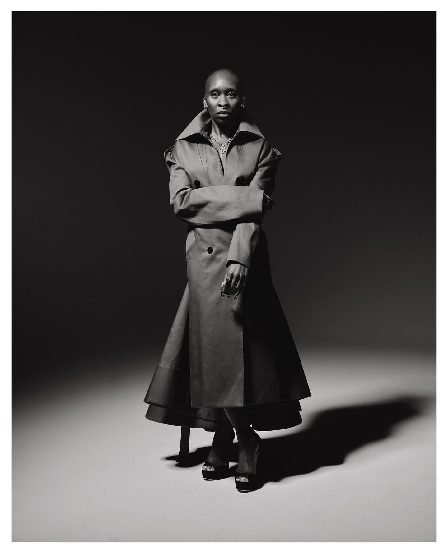 Cynthia Erivo wearing a long double-breasted coat with an oversized collar in a studio portrait by Erik Carter