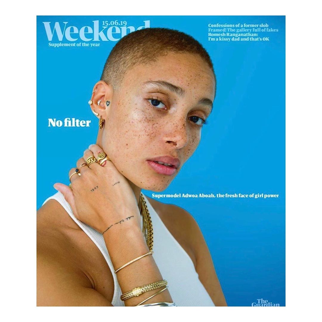Adwoa Aboah on magazine cover, close-up portrait with blue background. Model showcases multiple earrings, rings, and bracelets. Text: 'No Filter'.