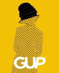 Back view of a person wearing a polka dot coat and black hat against a solid yellow background