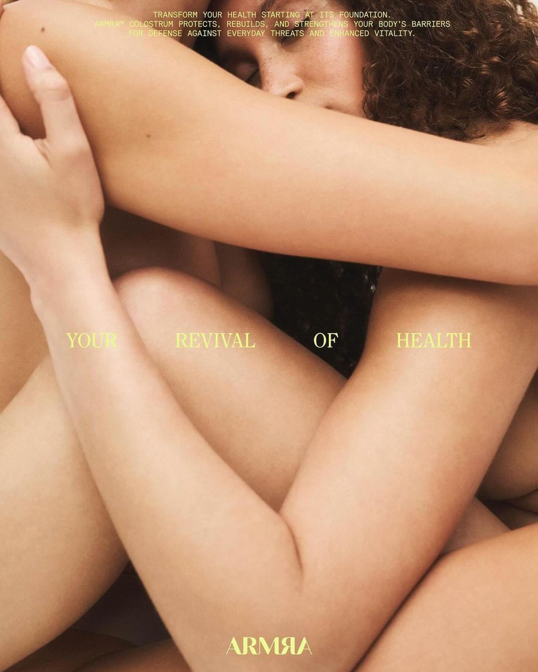 Close-up shot of two adults embracing; their arms intertwined, heads close, and bodies pressed together under soft, diffused lighting.