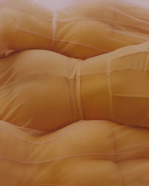 Overlapping images of women's torsos wrapped in a sheer orange fabric, creating an abstract yet sensual visual texture and form.