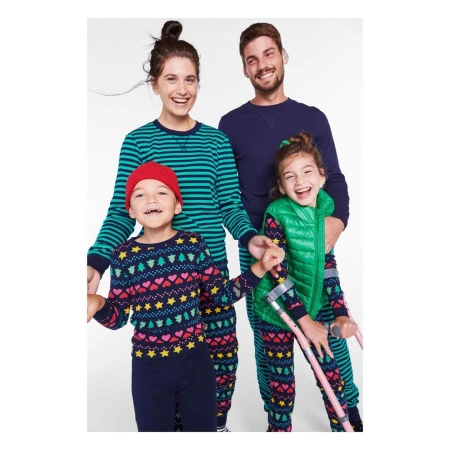 Family of four laughing together against a white background, captured by photographer Erin Foster.
