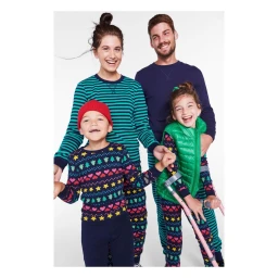Family of four laughing together against a white background, captured by photographer Erin Foster.
