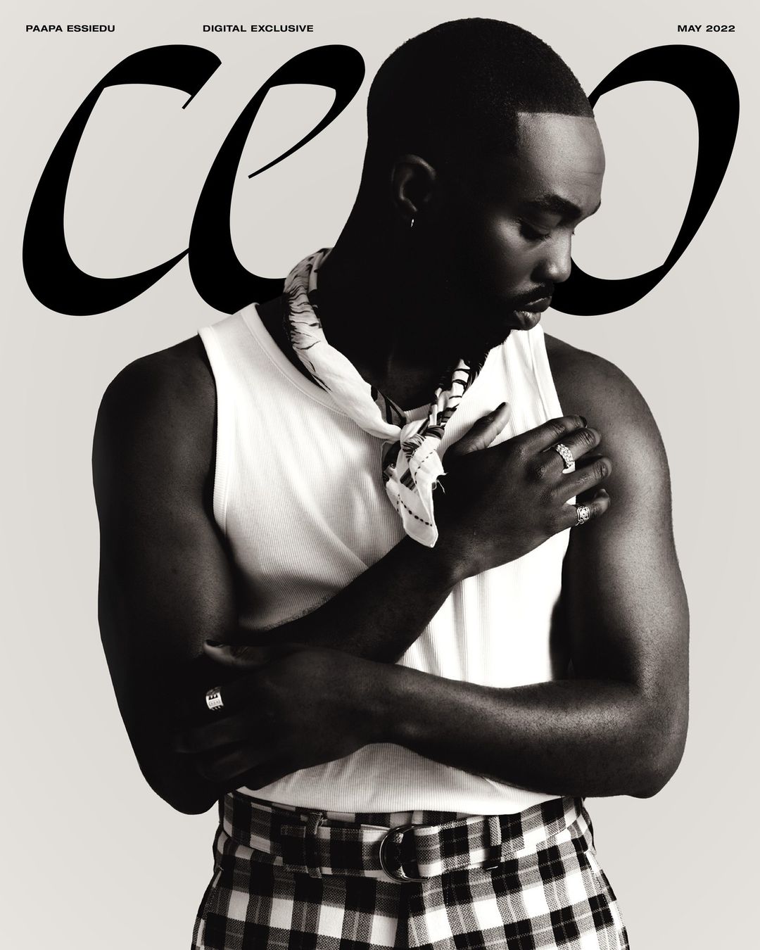 Black-and-white magazine cover featuring a stylish Black male model in a white tank top and checkered pants, with bold magazine text.