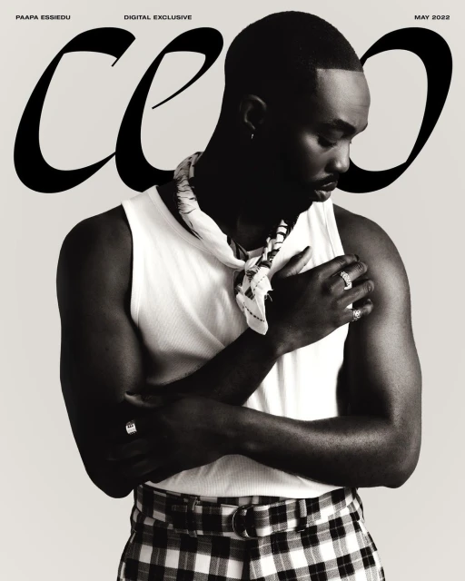 Black-and-white magazine cover featuring a stylish Black male model in a white tank top and checkered pants, with bold magazine text.