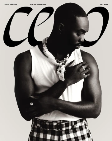 Black-and-white magazine cover featuring a stylish Black male model in a white tank top and checkered pants, with bold magazine text.