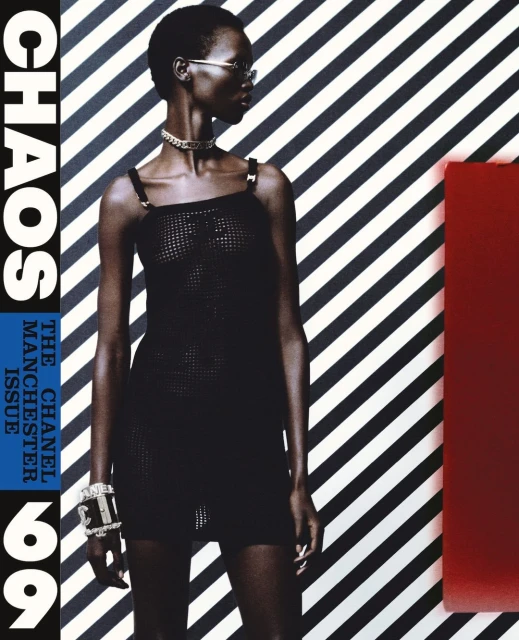 Fashion magazine cover featuring a Black female model in a black dress, accessorized with jewelry, against a striped background with text.