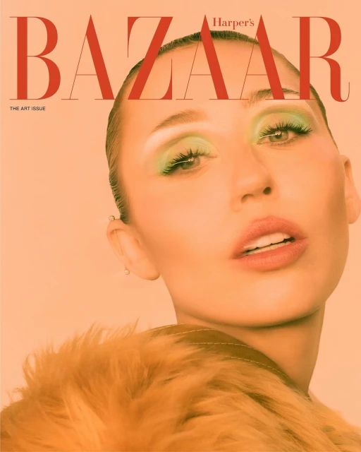 Harper's Bazaar magazine cover features a portrait of a woman with green eye makeup and a fur coat against a peach-colored background.