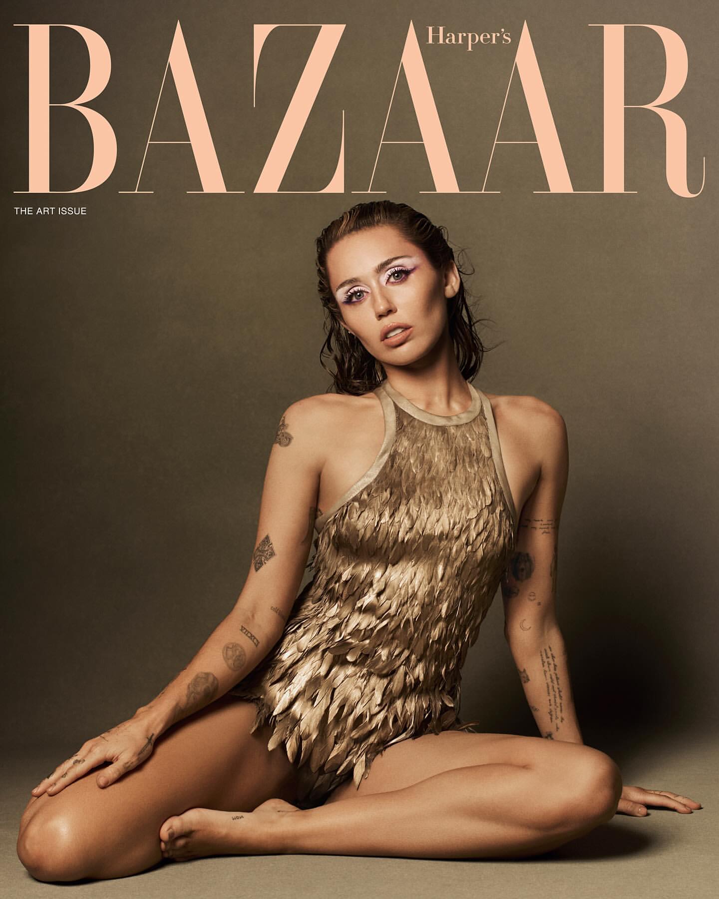 Harper's Bazaar cover featuring an adult female model with wet hair and dramatic makeup, wearing a gold feathered bodysuit, posing in a studio.