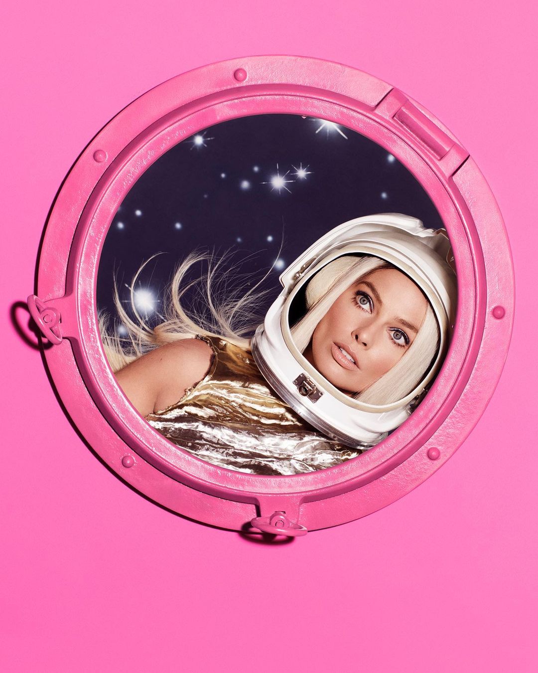 Blonde woman in a white astronaut helmet, seen through a pink round window, looks off to the right against a starry background.