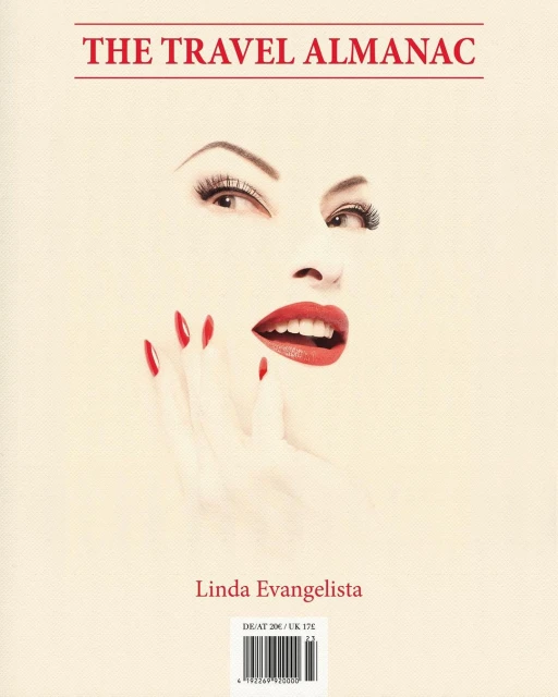 Book cover art featuring a woman's face with red lips and fingernails, titled 'The Travel Almanac' and crediting Linda Evangelista.