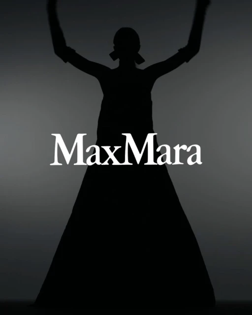 Silhouette of a woman in a long dress with her arms raised against a gradient gray background, featuring the Max Mara logo.