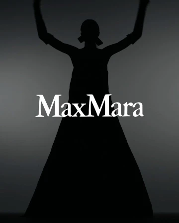 Silhouette of a woman in a long dress with her arms raised against a gradient gray background, featuring the Max Mara logo.