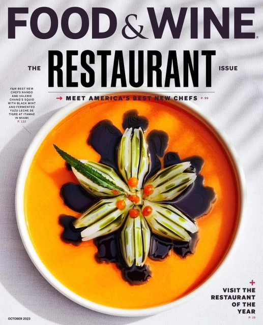 Food & Wine magazine cover featuring a vibrant orange soup with a flower-shaped garnish made of vegetables and dark sauce.