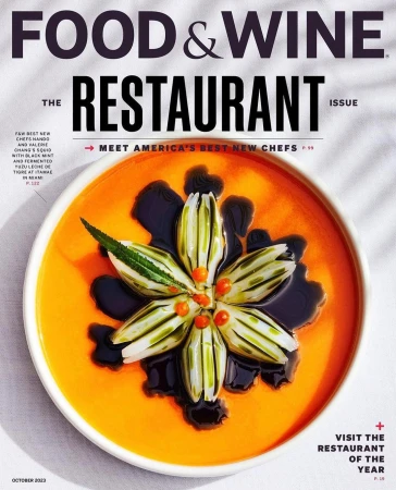 Food & Wine magazine cover featuring a vibrant orange soup with a flower-shaped garnish made of vegetables and dark sauce.