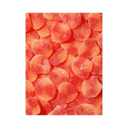 Close up overhead view of numerous red and orange sugared gummy candies piled together.