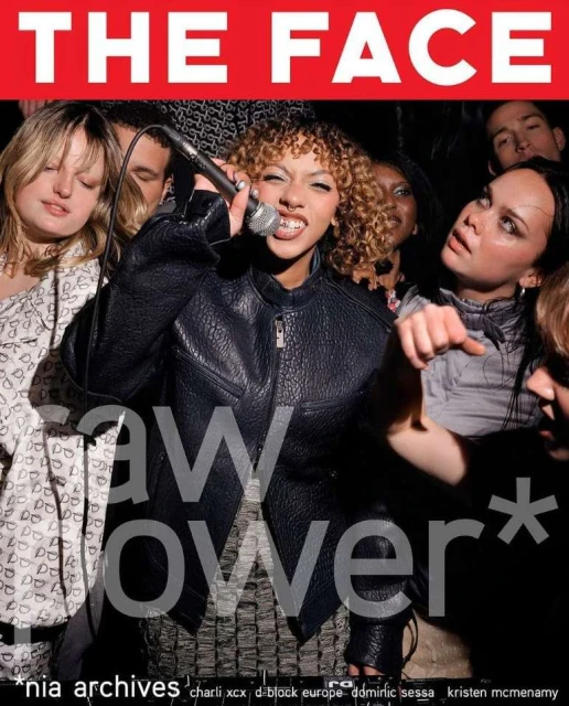 Magazine cover featuring a singer with a microphone, surrounded by several other individuals in a dimly lit setting with red branding.