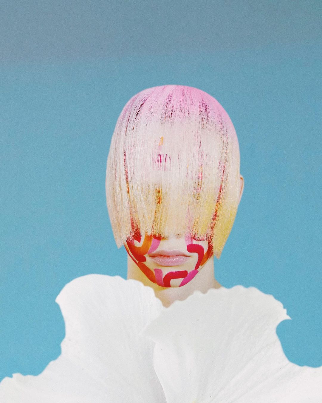 Abstract portrait of a person with painted face and pink hair, adorned with large white petal-like collar against a blue background.