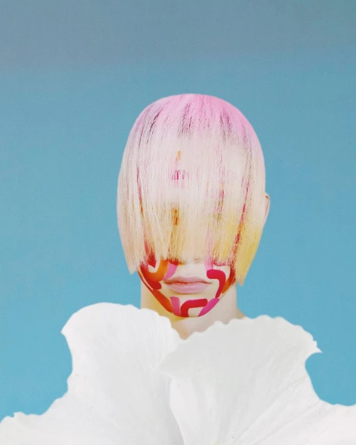 Abstract portrait of a person with painted face and pink hair, adorned with large white petal-like collar against a blue background.