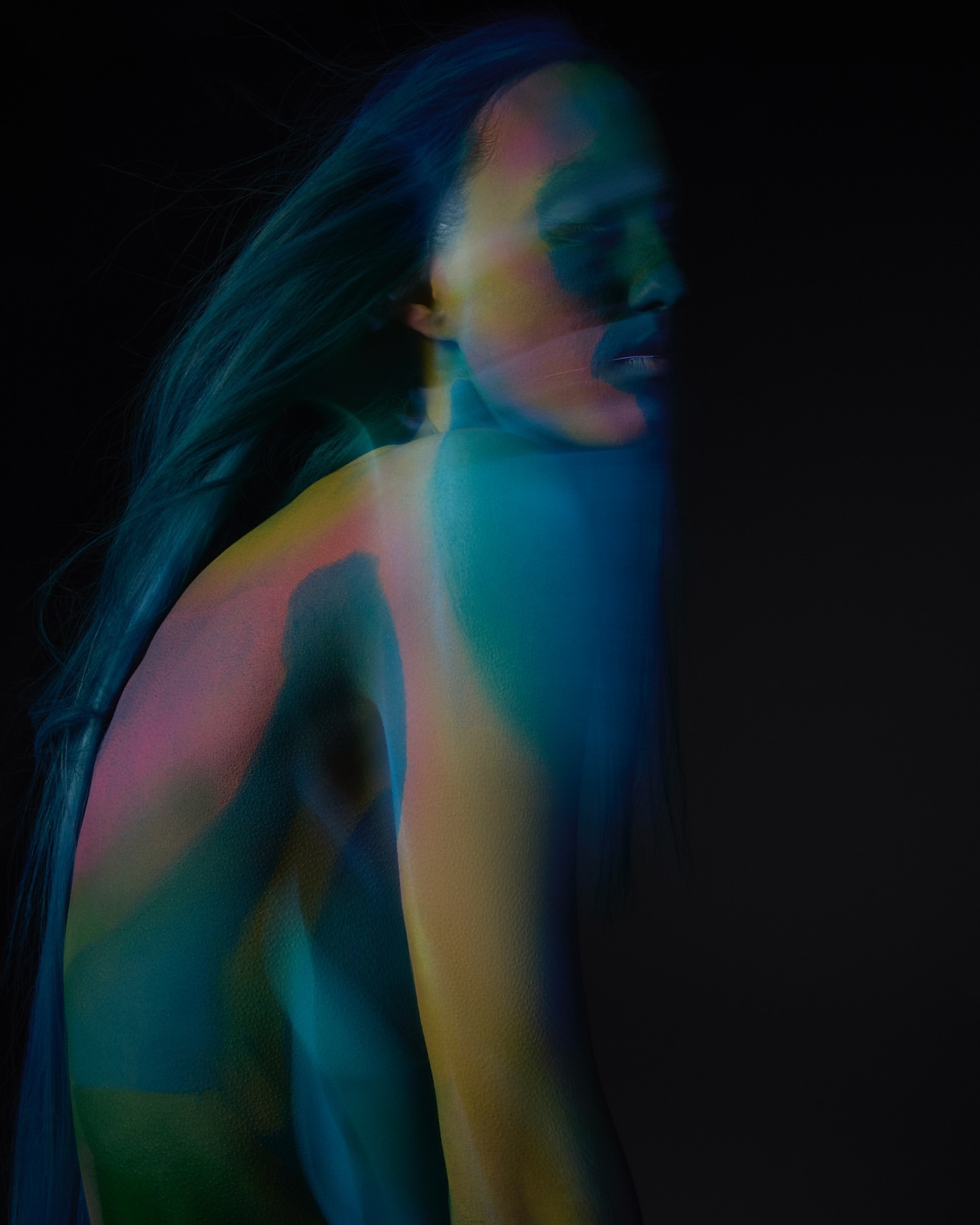 Abstract portrait of an adult with flowing hair, rendered in blended turquoise, blue, yellow, and pink hues against a dark background.