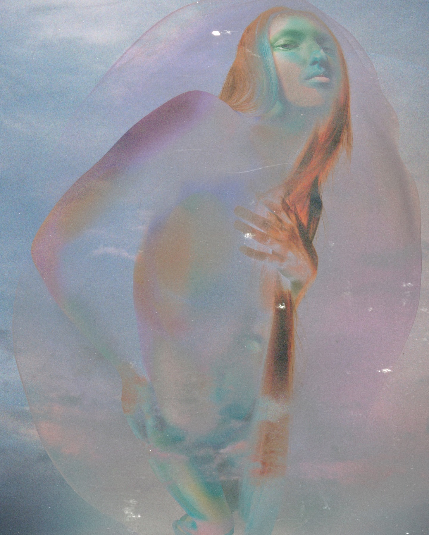 Portrait of a woman viewed through a large soap bubble with iridescent light refraction under a blue sky