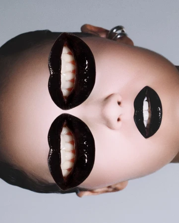 Surreal beauty portrait with an adult female face and digitally added black glossy lips with teeth, creating a multi-mouth effect.