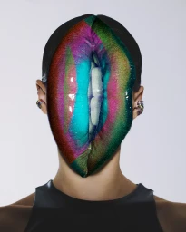 Close-up portrait of a person with a giant, glossy, multicoloured pair of lips covering their face.