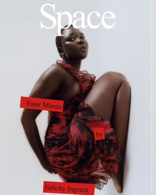 Editorial fashion shot featuring an African-descent female model in a red tie-dye dress, set against a bright, clean background.