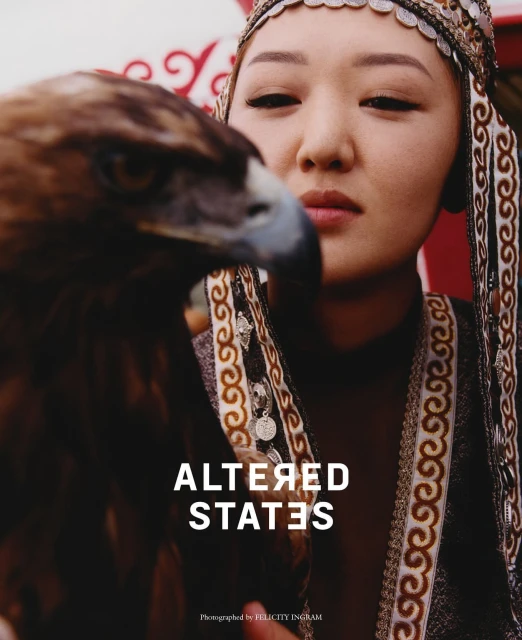 Portrait of an asian woman in traditional clothing with an eagle, close-up shot with shallow depth of field, outdoor setting. Fashion editorial.