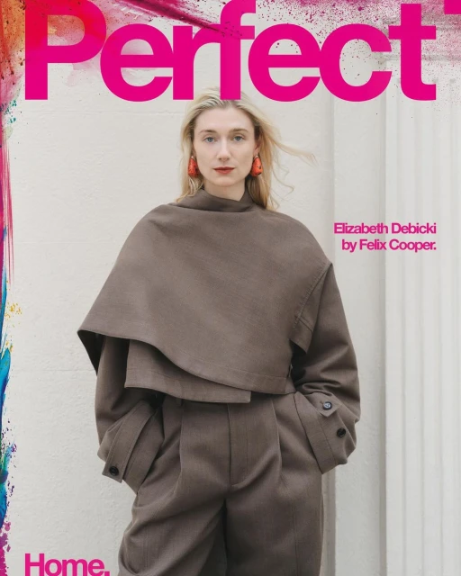 Elizabeth Debicki on the cover of Perfect magazine, wearing a tan layered outfit with architectural earrings in an indoor setting.