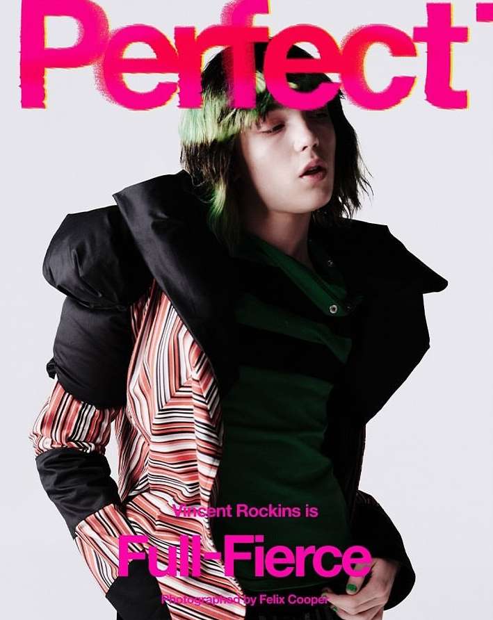 Magazine cover featuring a person with dyed hair, wearing a jacket, and posing in front of a plain white background.