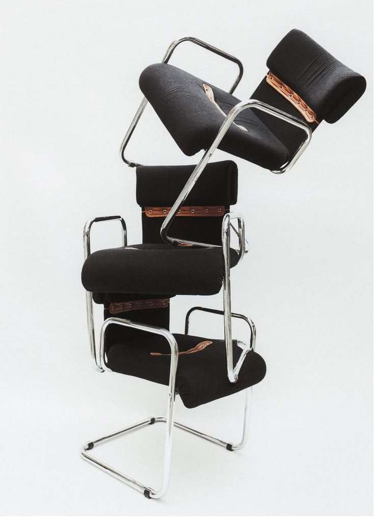 Conceptual product shot of three black Cesca chairs stacked on top of each other, set against a stark white background in a photo studio.