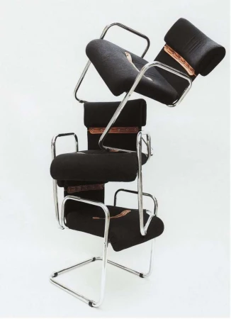 Conceptual product shot of three black Cesca chairs stacked on top of each other, set against a stark white background in a photo studio.
