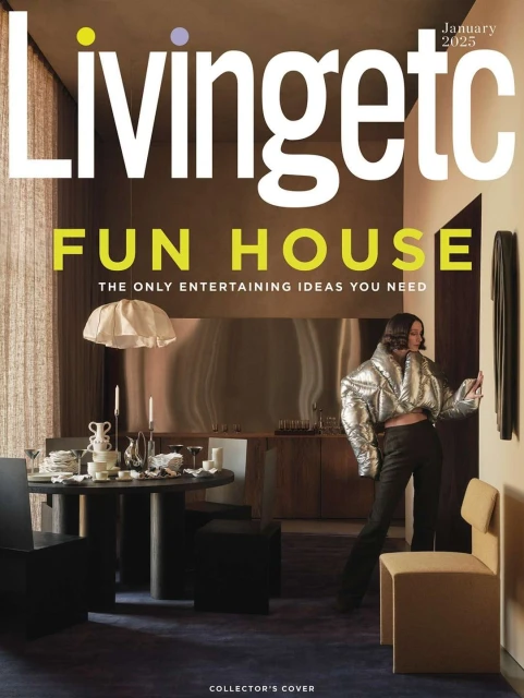 Magazine cover features a woman in a silver puffer jacket standing in a stylish room with a round table and unique chairs.