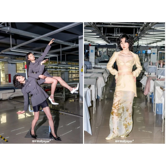 Two Asian women in a factory setting. One woman stands while holding another woman horizontally in the air with arms extended.