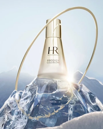 Elegant gold skincare product from Helen Rubinstein, set on a chunk of ice with snowy mountains in the background, and gold arch.