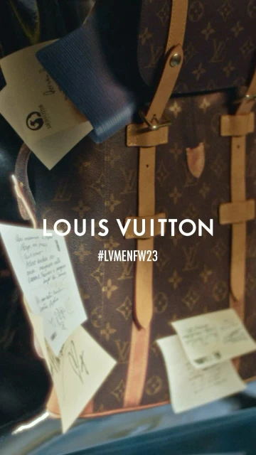 Louis Vuitton brand luggage bag in a fashion-oriented indoor studio setting with scattered handwritten notes and soft studio lighting.