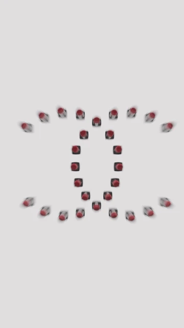 Red lipstick tubes are arranged in a repeating pattern on a bright white surface, creating an eye-catching abstract design.
