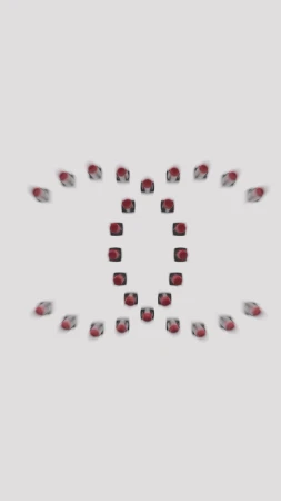 Red lipstick tubes are arranged in a repeating pattern on a bright white surface, creating an eye-catching abstract design.