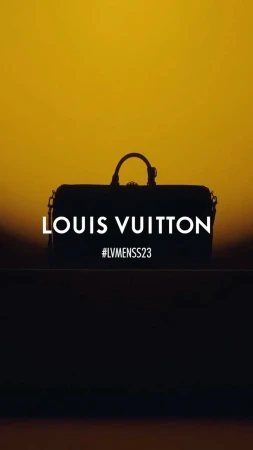 Silhouette of a Louis Vuitton duffel bag against a golden sky, featuring the brand name and #LVMENSS23 in a minimalist composition.